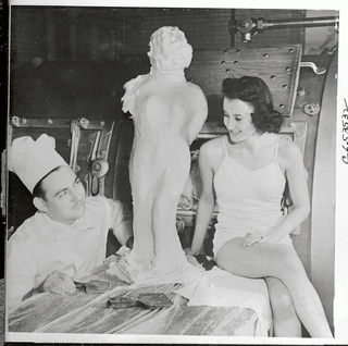 Herman Neubauer, one of the eight spies landed from German U-boat on a sabotage mission in the U.S., is under arrest in Chicago. In 1938 he was chef at a hotel here, where he carved this statue in butter using Betty Roberts as model. (Photo: Bettmann/Getty Images)